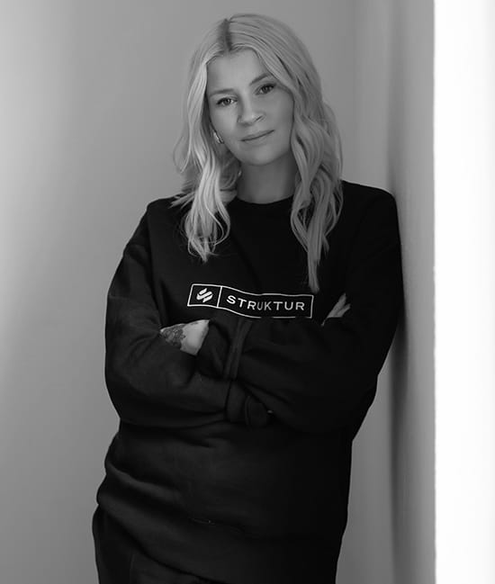 a woman leaning against a wall